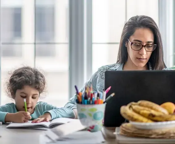 A working woman practicing work-life balance next to her daughter