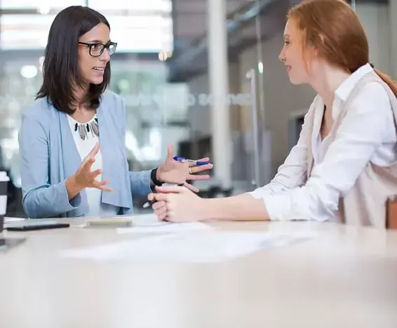 business woman conducting stay interview with her employee